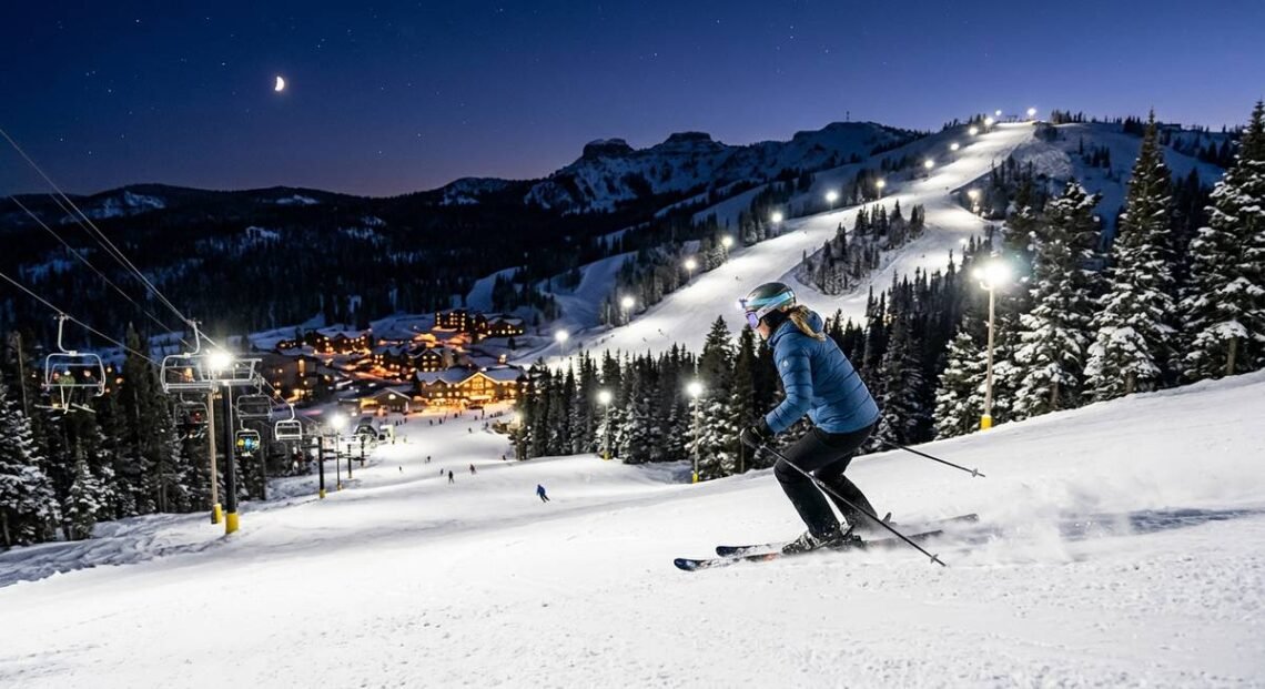 Illuminated ski slopes at Brian Head Resort during a night skiing session under bright lights against a dark Utah sky