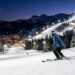 Illuminated ski slopes at Brian Head Resort during a night skiing session under bright lights against a dark Utah sky
