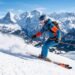 Skier carving down a snowy mountain slope — complete guide to calories burned skiing