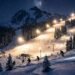 Mt Baker night skiing with illuminated slopes and skiers carving through fresh powder under stadium lights