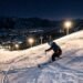 Powder Mountain night skiing with lit runs descending through snow-covered terrain under evening lights in Eden, Utah