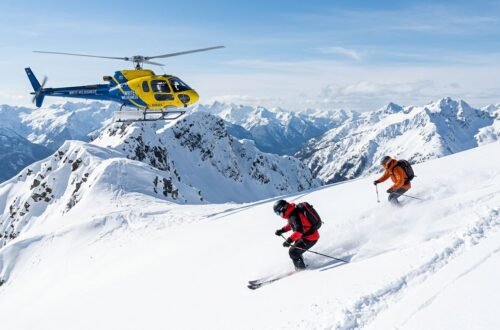 white wilderness heli skiing operation near Terrace BC with Coast Mountain backdrop and helicopter on snow