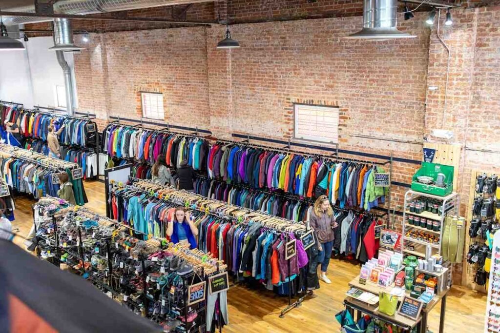 Outdoor gear store with racks of discounted ski jackets and boots, the best time to buy ski gear scene