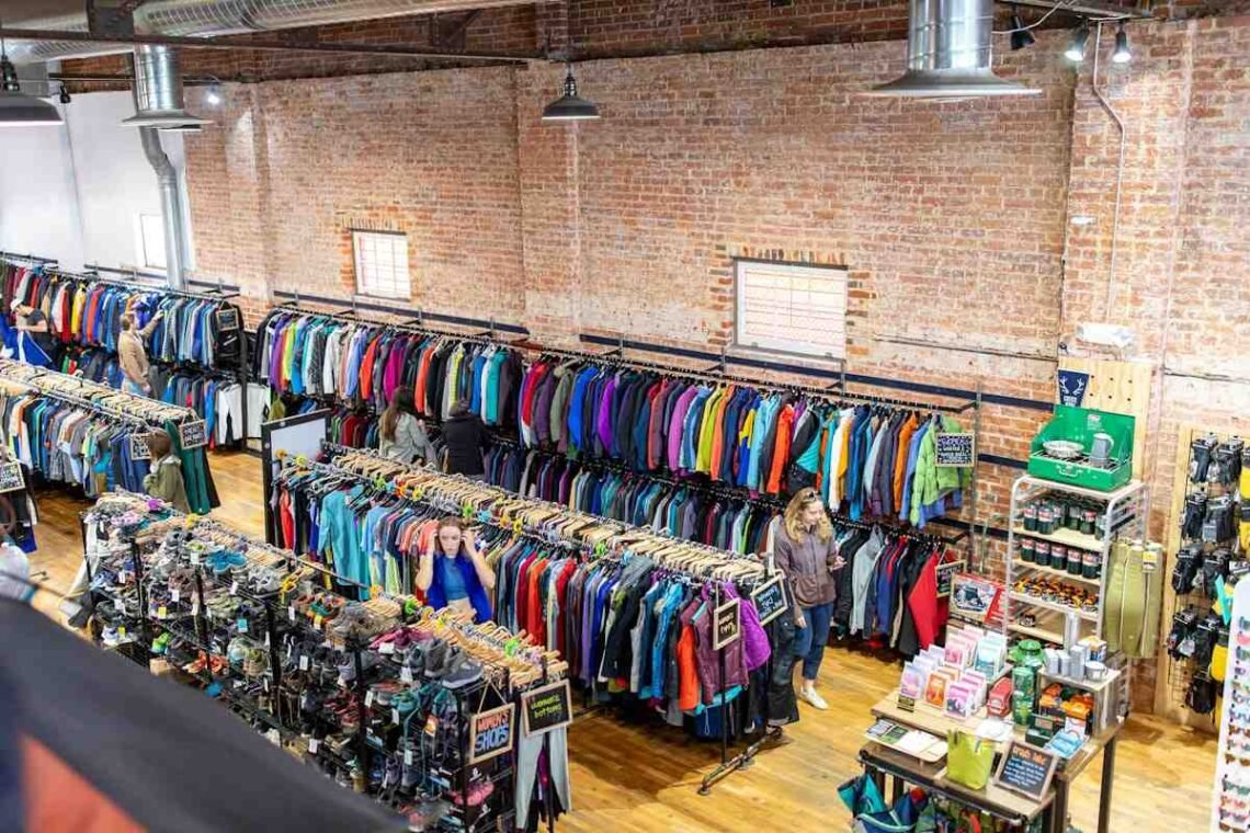Outdoor gear store with racks of discounted ski jackets and boots, the best time to buy ski gear scene