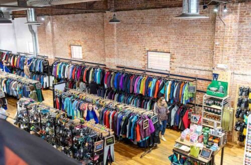 Outdoor gear store with racks of discounted ski jackets and boots, the best time to buy ski gear scene