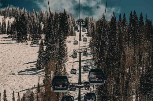 Steamboat gondola cabins climbing a snowy ridge, an Ikon Pass unlimited resort in the epic vs ikon pass decision