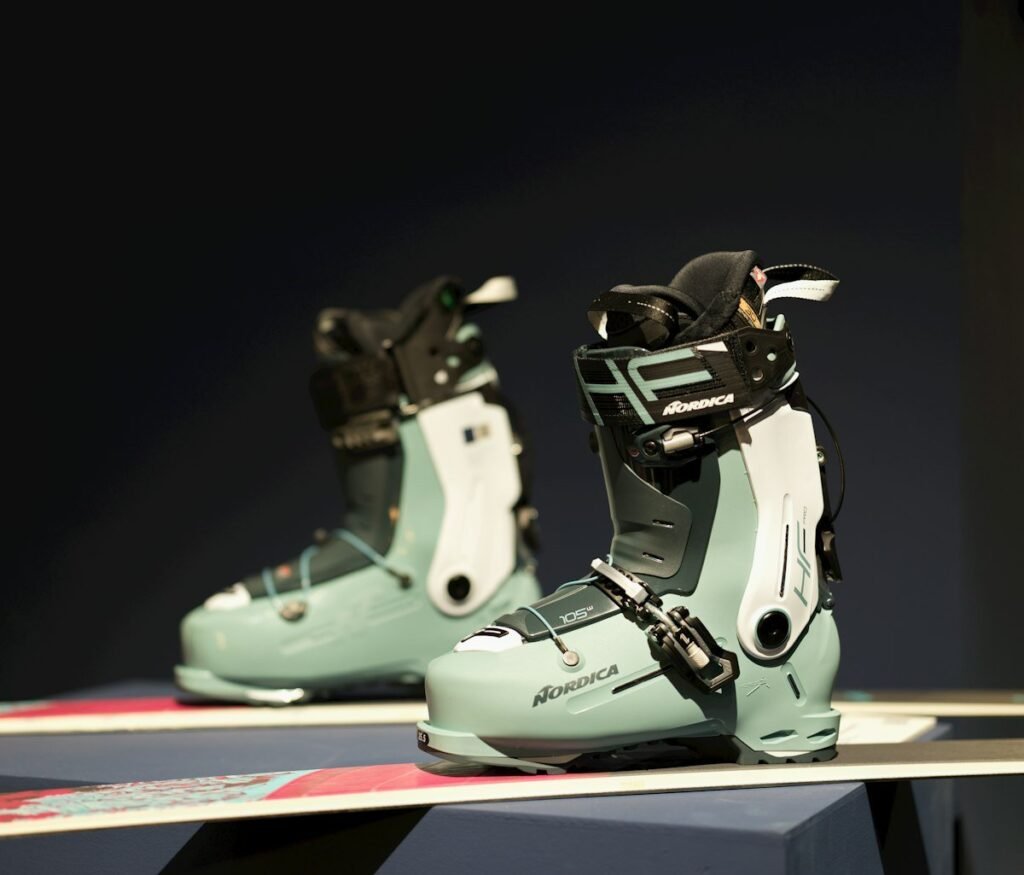 Pair of modern ski boots on a display bench, the starting point for diagnosing ski boot pain